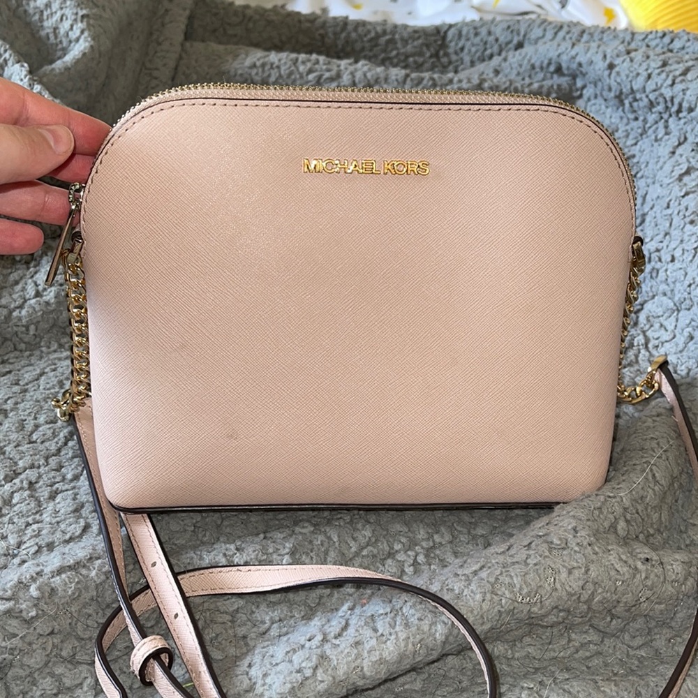 Light pink/gold Michael Kors crossbody bag. Very cute but just sits in my closet
